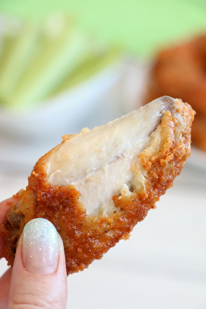 Air Fryer Chicken Wings - Delicious hot wings made in the air fryer in under 20 minutes. Use the sauce recipe provided or choose your favorite sauce!