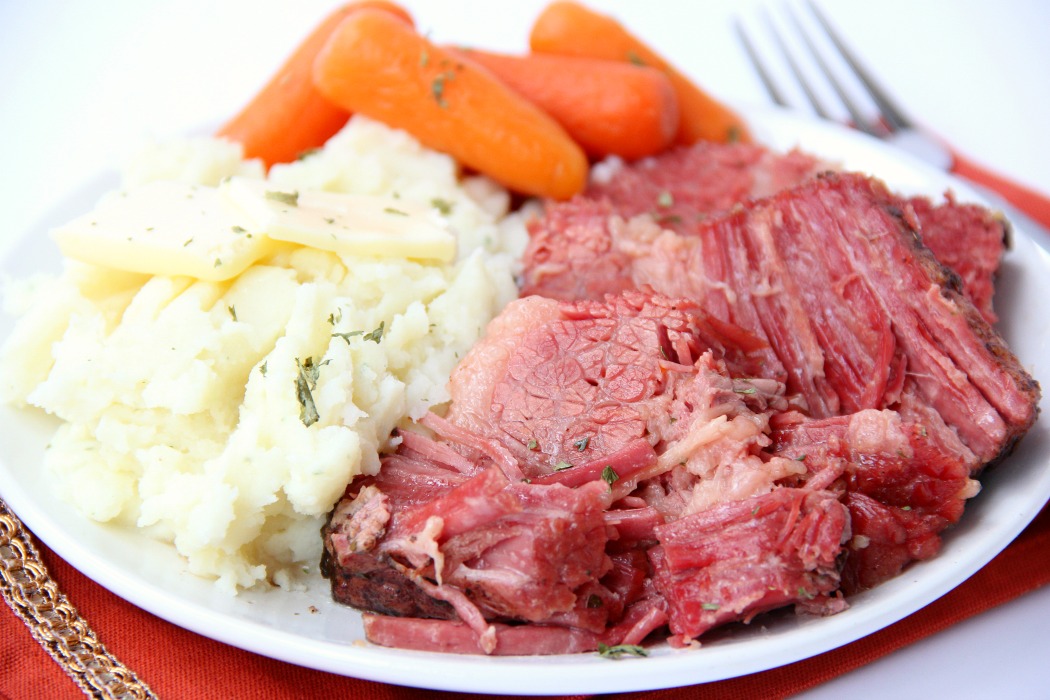 Instant Pot Corned Beef - Deliciously tender, juicy and flavorful corned beef and baby carrots made in your Instant Pot or Ninja Foodi in under two hours!