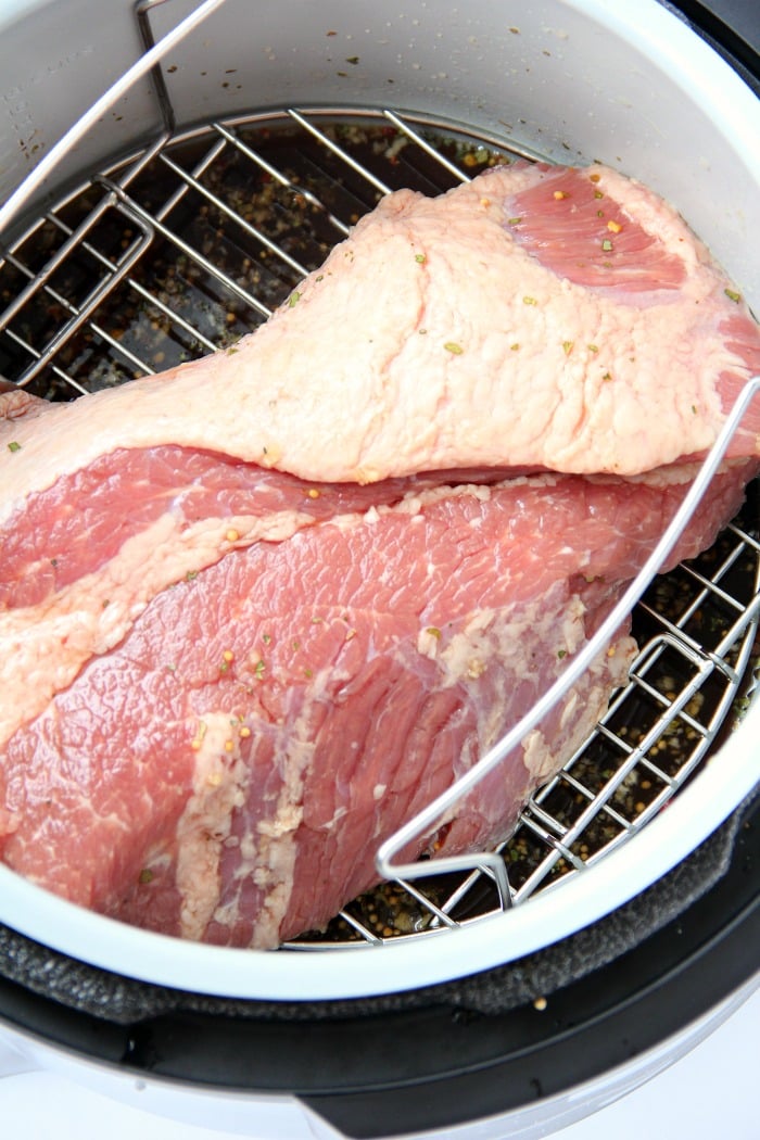 Instant Pot Corned Beef - Deliciously tender, juicy and flavorful corned beef and baby carrots made in your Instant Pot or Ninja Foodi in under two hours!