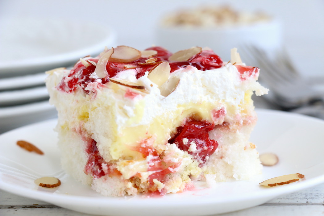 No Bake Cherry Dump Cake - An easy, no-bake cherry trifle dessert withÂ layers of angel food cake, sour cream, pudding, cherry pie filling and whipped topping.