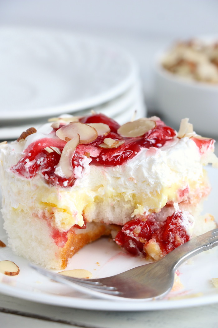 No Bake Cherry Dump Cake - An easy, no-bake cherry trifle dessert withÂ layers of angel food cake, sour cream, pudding, cherry pie filling and whipped topping.