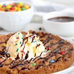 Air Fryer Pizookie - A soft and chewy cookie filled with mini chocolate chips and M&Ms made right in the air fryer in under 10 minutes! Large enough to serve a crowd!
