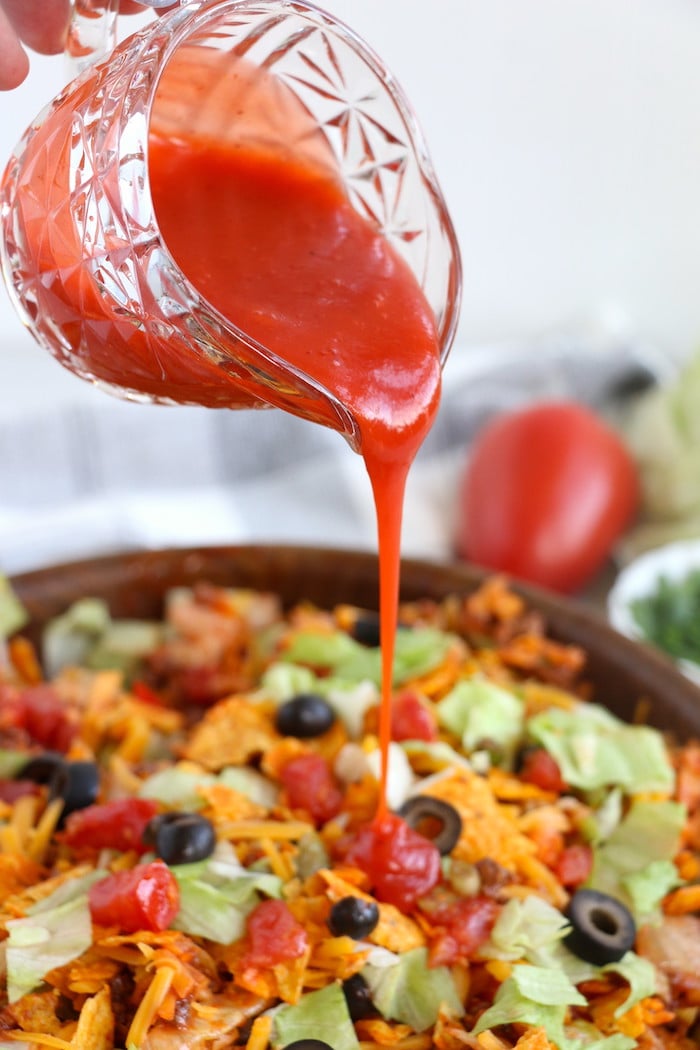 Dorito Taco Salad - This crunchy and zesty salad is made with seasoned ground beef, veggies, cheese and Doritos, then tossed with Catalina dressing. So delicious and serves a crowd! 