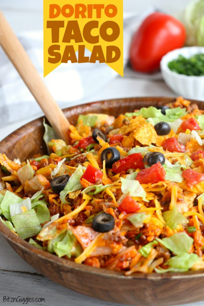 Dorito Taco Salad - This crunchy and zesty salad is made with seasoned ground beef, veggies, cheese and Doritos, then tossed with Catalina dressing. So delicious and serves a crowd!