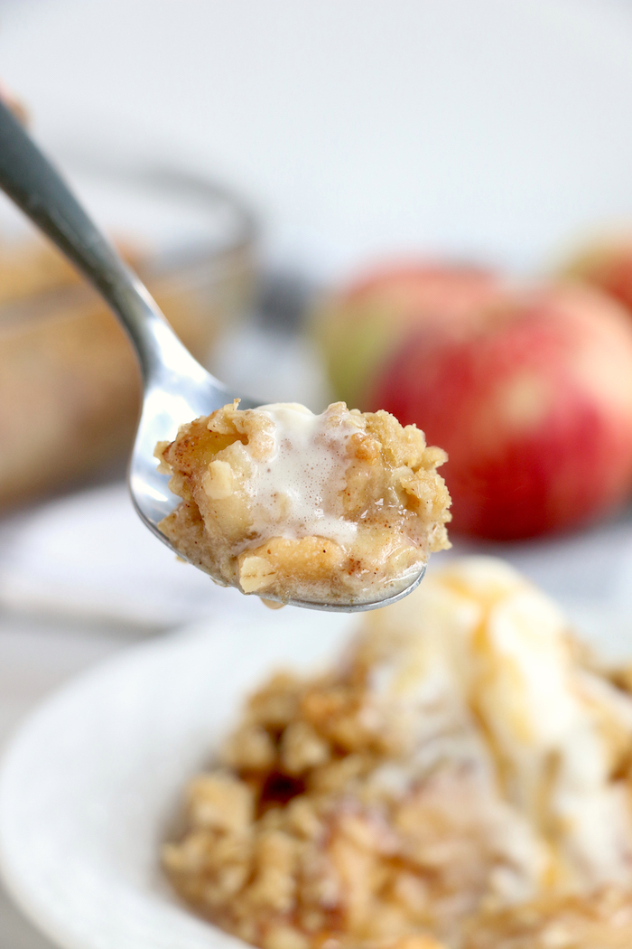 Easy Apple Crisp - A delicious, old-fashioned crisp made with sliced apples and a crunchy brown sugar oat topping. A scoop of vanilla ice cream and salted caramel sauce puts it over the top!