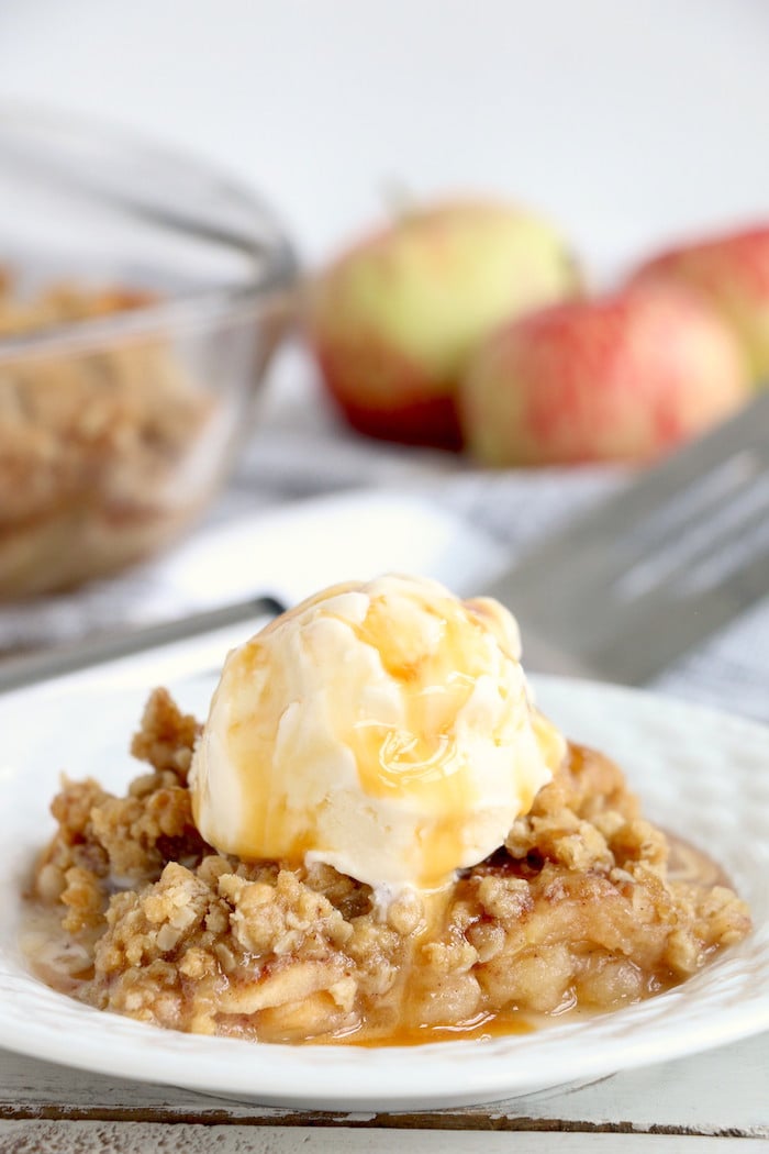 Easy Apple Crisp - A delicious, old-fashioned crisp made with sliced apples and a crunchy brown sugar oat topping. A scoop of vanilla ice cream and salted caramel sauce puts it over the top!