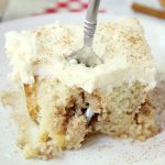 Cinnamon Roll Poke Cake - A soft and moist poke cake filled with a sweet cinnamon filling and topped with a homemade cream cheese frosting that melts in your mouth.