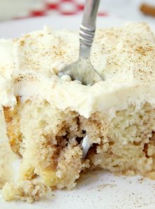 Cinnamon Roll Poke Cake - A soft and moist poke cake filled with a sweet cinnamon filling and topped with a homemade cream cheese frosting that melts in your mouth.