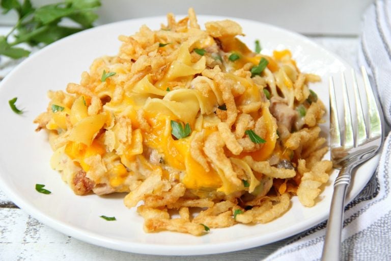 Classic Tuna Noodle Casserole - Ready in under 45 minutes, this classic and comforting casserole features tuna, onions, mushrooms, peas and cheese in a creamy sauce topped with more cheese and crunchy French fried onions! So flavorful, and sure to satisfy the entire family!