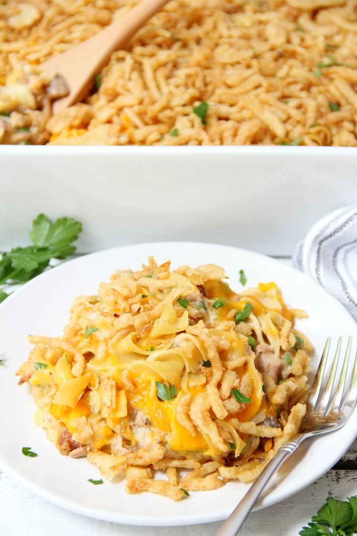 Classic Tuna Noodle Casserole - Ready in under 45 minutes, this classic and comforting casserole features tuna, onions, mushrooms, peas and cheese in a creamy sauce topped with more cheese and crunchy French fried onions! So flavorful, and sure to satisfy the entire family! 
