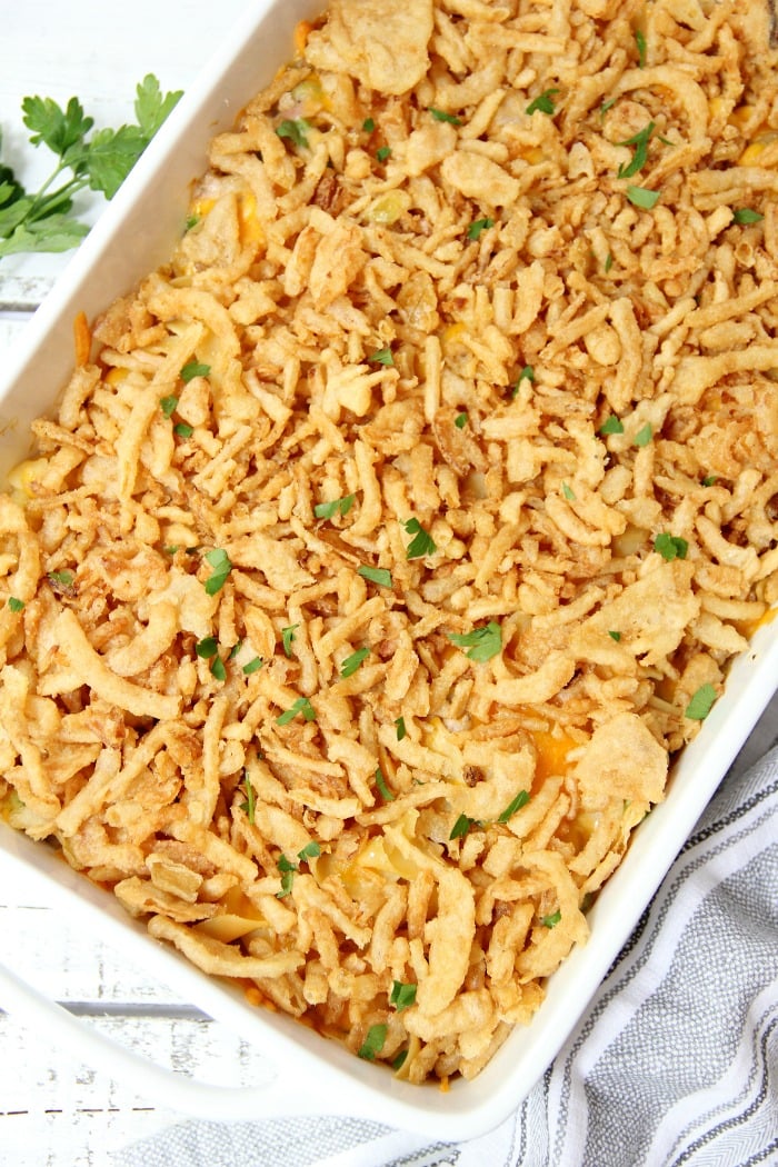 Classic Tuna Noodle Casserole - Ready in under 45 minutes, this classic and comforting casserole features tuna, onions, mushrooms, peas and cheese in a creamy sauce topped with more cheese and crunchy French fried onions! So flavorful, and sure to satisfy the entire family! 