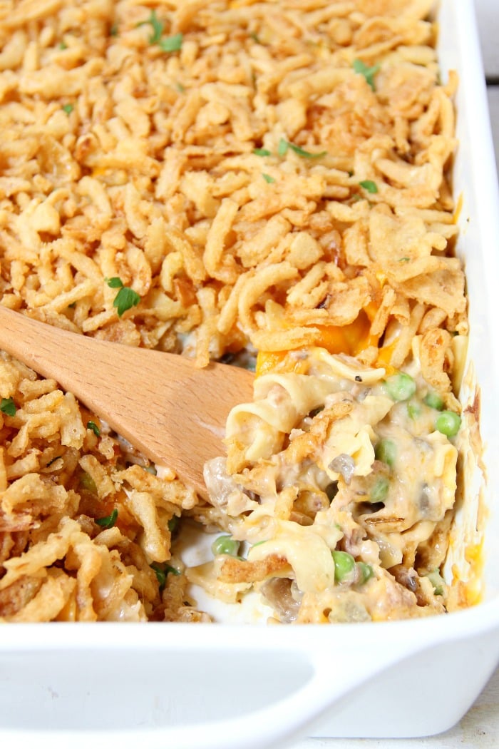 Classic Tuna Noodle Casserole - Ready in under 45 minutes, this classic and comforting casserole features tuna, onions, mushrooms, peas and cheese in a creamy sauce topped with more cheese and crunchy French fried onions! So flavorful, and sure to satisfy the entire family! 