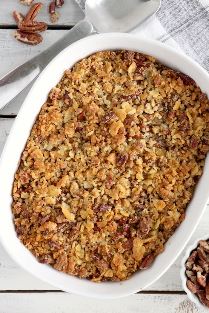 Easy Sweet Potato Casserole - An easy and delicious casserole that comes together with no scrubbing, boiling or baking the sweet potatoes! Topped with a sweet, salty and crunchy streusel, your guests will devour this simple and tasty side dish!