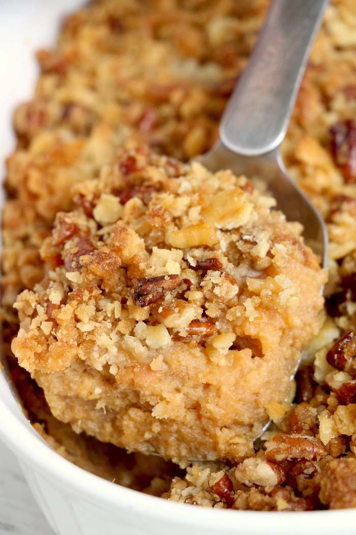 Easy Sweet Potato Casserole - An easy and delicious casserole that comes together with no scrubbing, boiling or baking the sweet potatoes! Topped with a sweet, salty and crunchy streusel, your guests will devour this simple and tasty side dish!