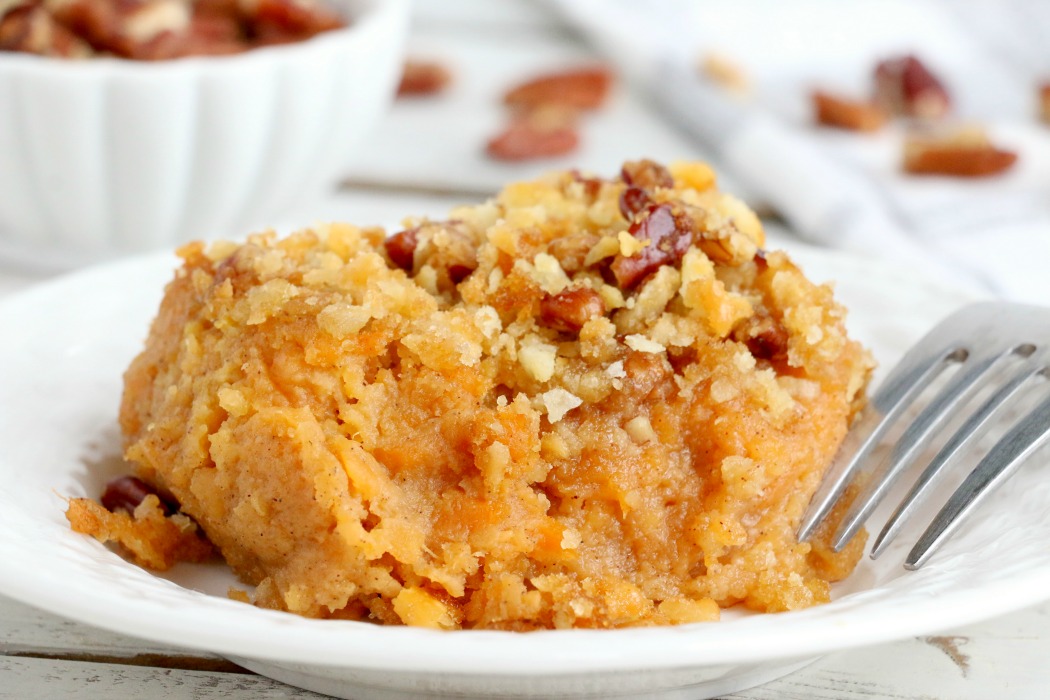 Easy Sweet Potato Casserole - An easy and delicious casserole that comes together with no scrubbing, boiling or baking the sweet potatoes! Topped with a sweet, salty and crunchy streusel, your guests will devour this simple and tasty side dish! 