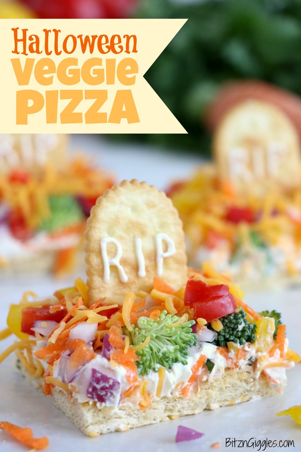 Halloween Veggie Pizza - A spooky themed graveyard pizza featuring a flavorful ranch cream cheese covered crust, topped with colorful veggies and "tombstone" crackers. 