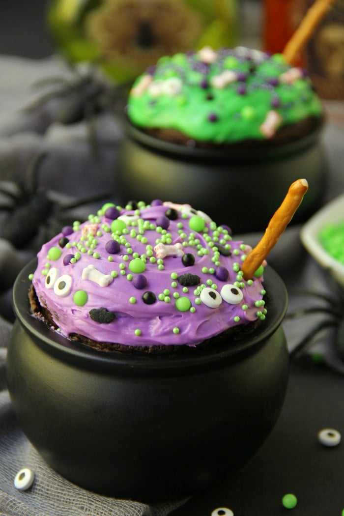 Witch Cauldron Mug Cake - A chocolate mug cake made in a ceramic witch cauldron with halloween-themed frosting and sprinkles! 