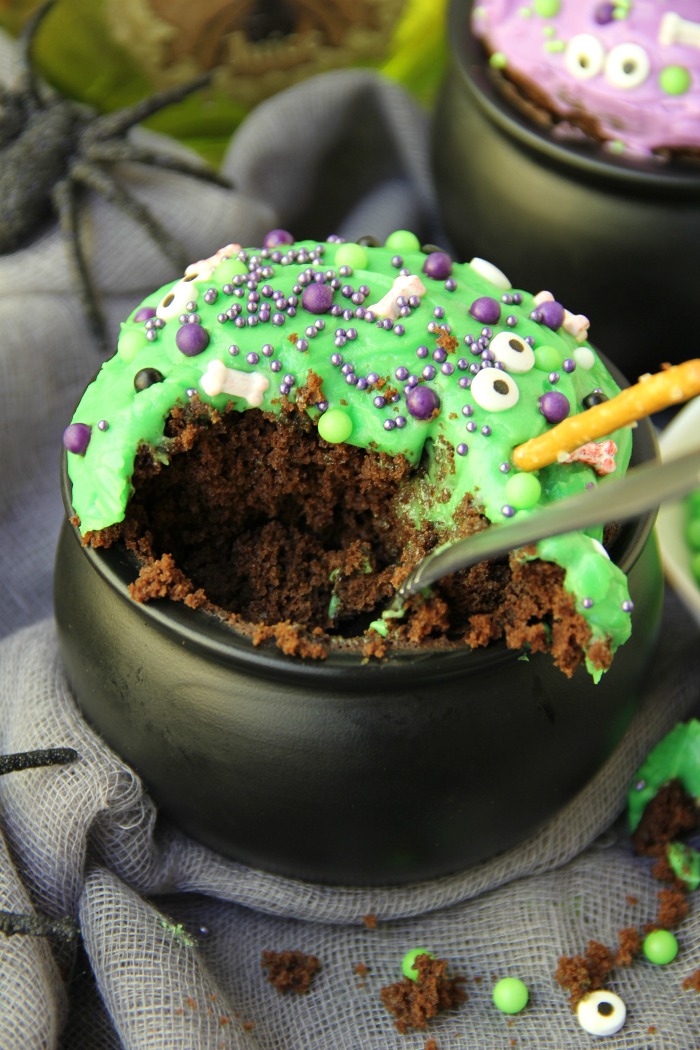 Witch Cauldron Mug Cake - A chocolate mug cake made in a ceramic witch cauldron with halloween-themed frosting and sprinkles! 