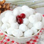 Cranberry Snowballs - Fresh cranberries rolled in powdered sugar then baked and chilled. Surprise your guests with a burst of delicious cranberry when they bite into these sweet and tangy confections!
