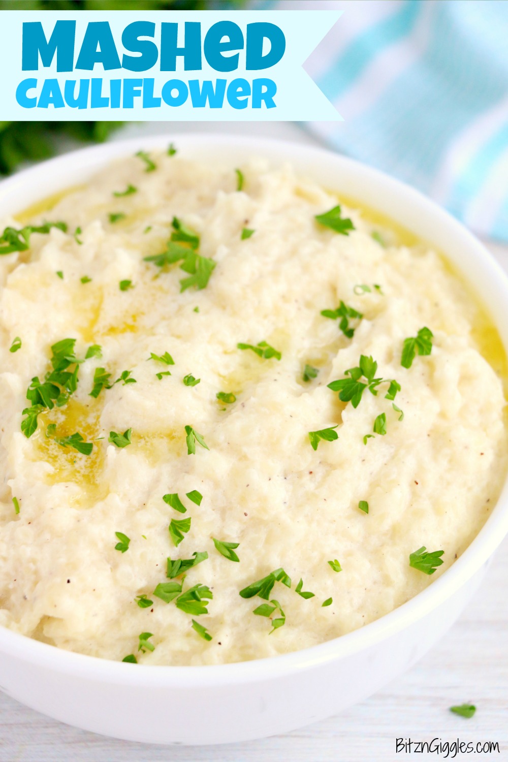 mashed cauliflower in a bowl with butter and parsley 
