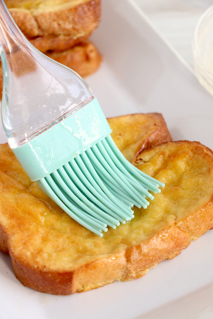 Brushing butter on French toast