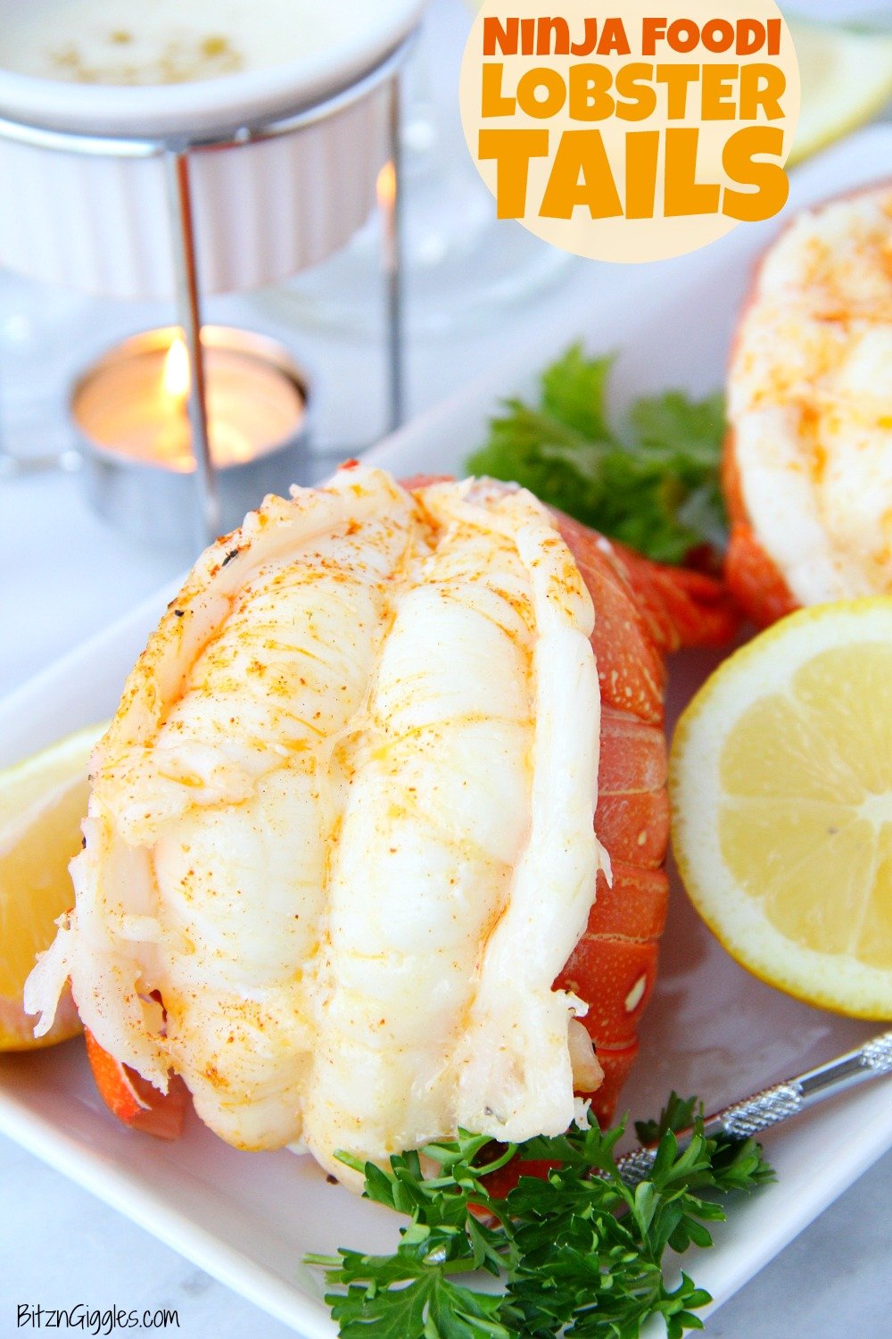 Lobster tails on table with melted butter and wine glass