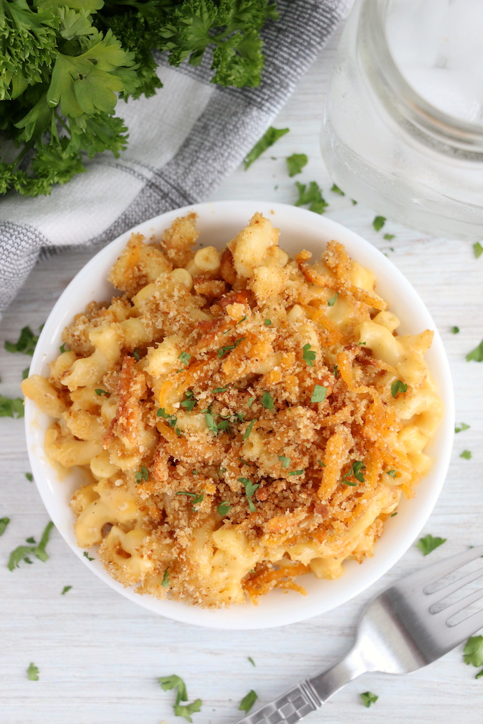 bowl of macaroni and cheese garnished with parsley