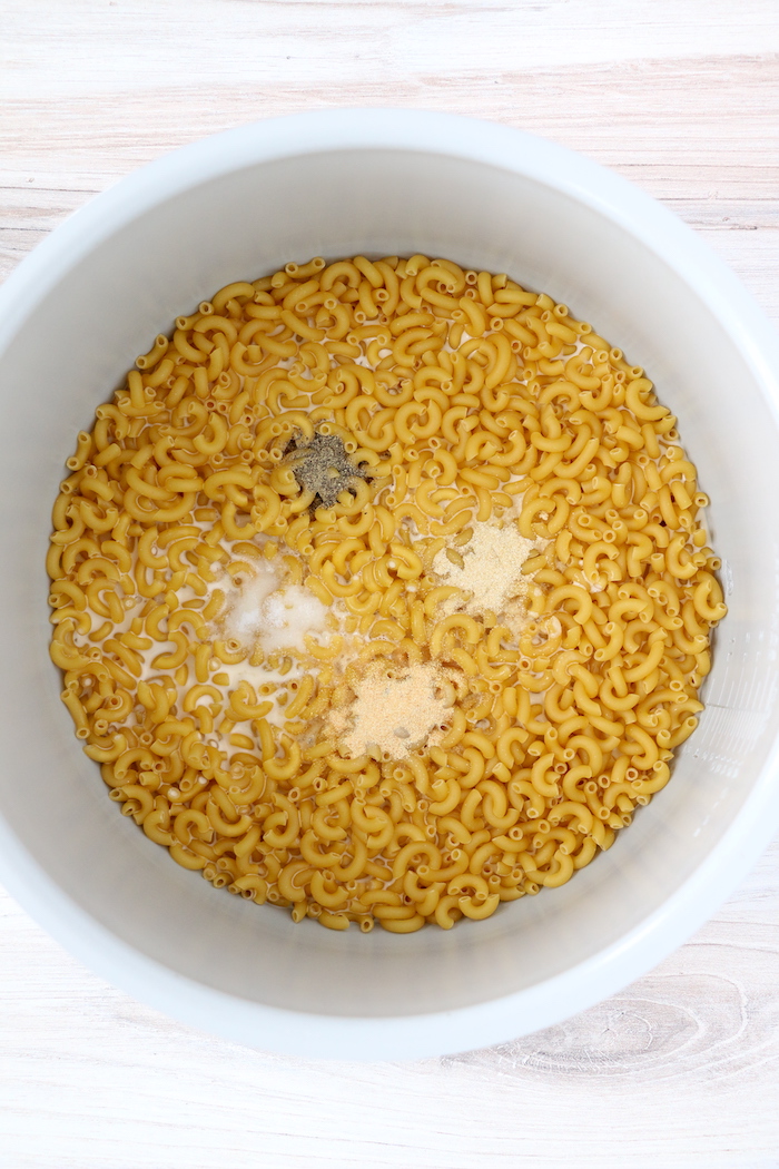 seasoning and pasta in Ninja Foodi cooking pot