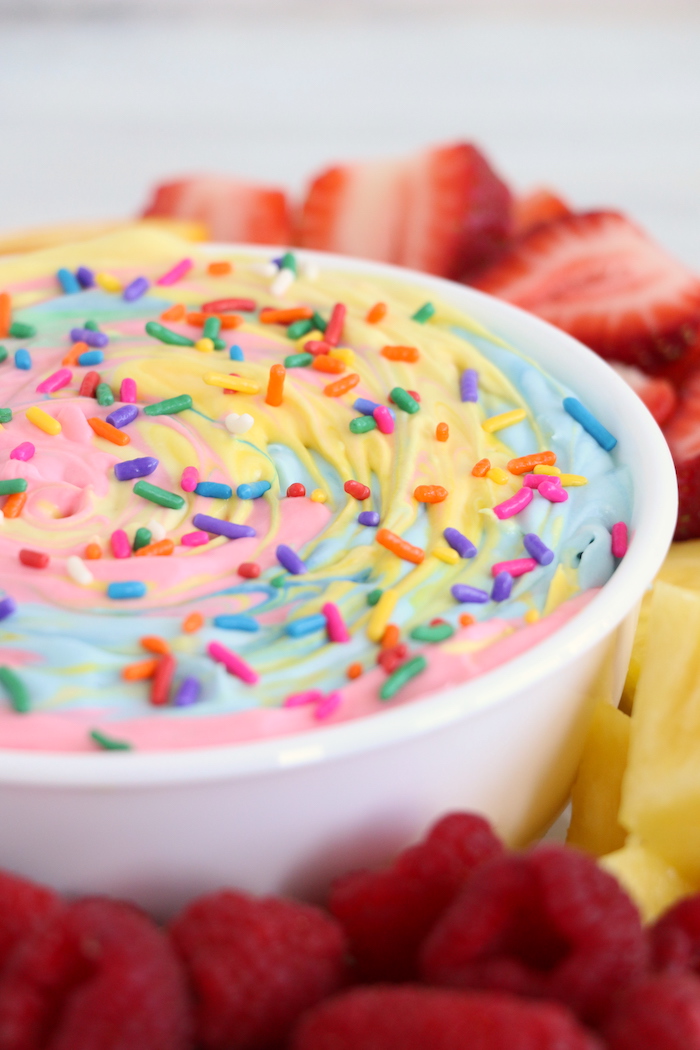 Rainbow sprinkle fruit dip in white bowl with fruit