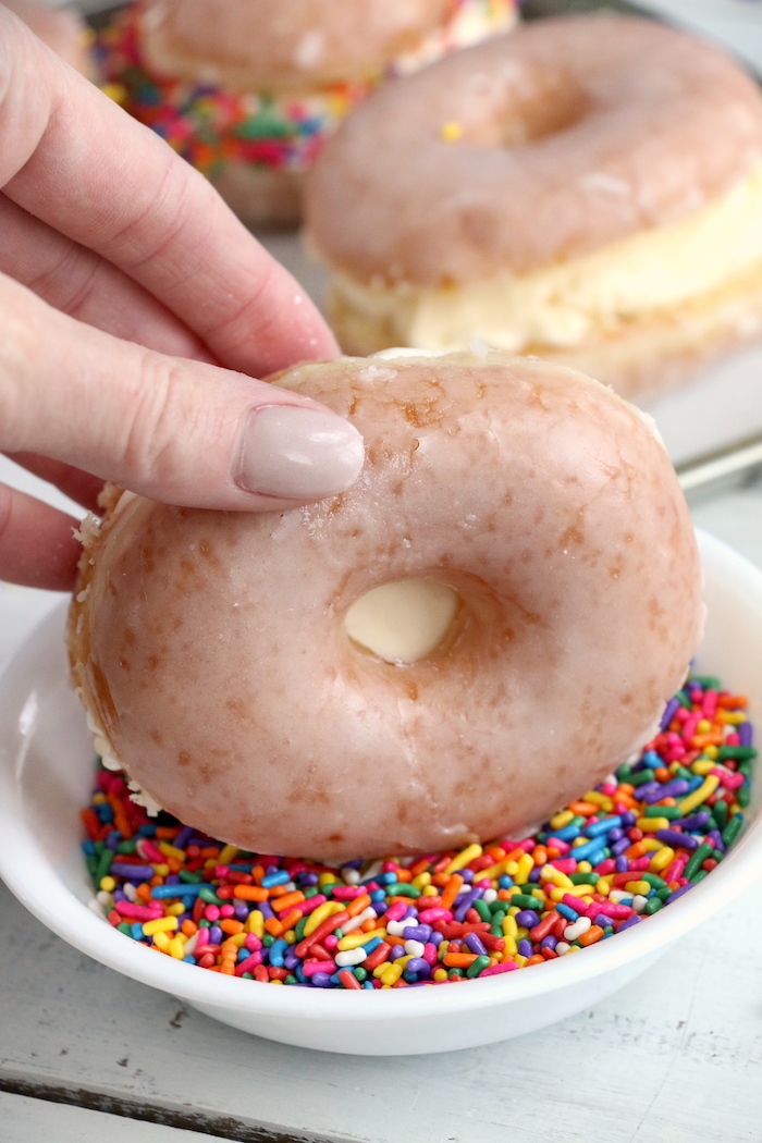 Rolling glazed donut in sprinkles