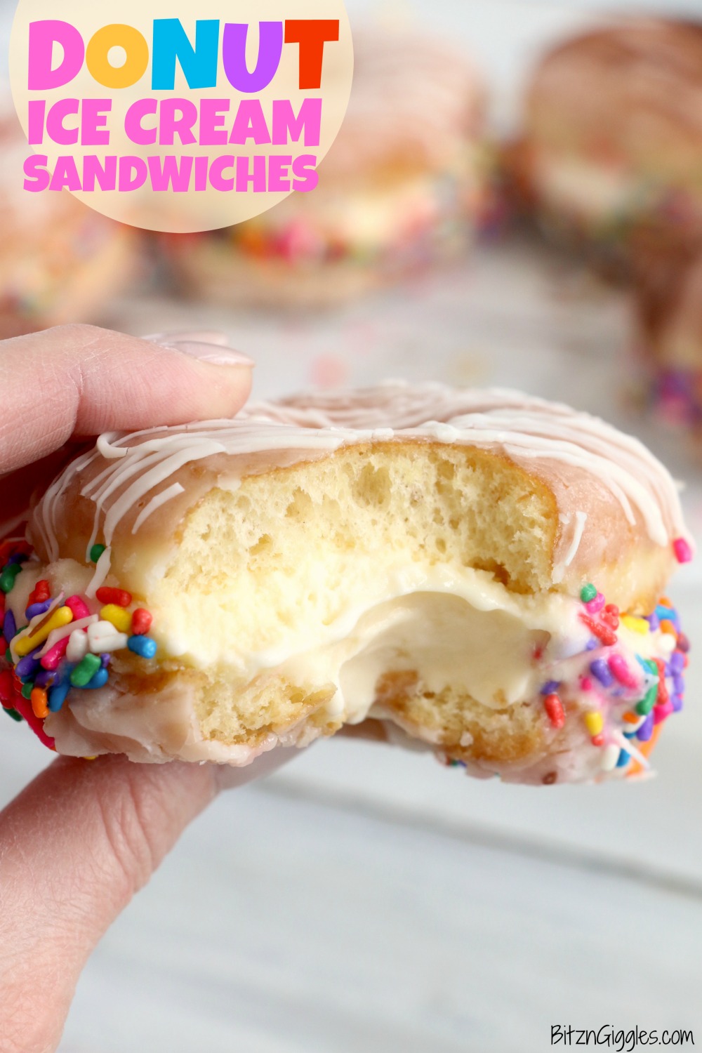 holding a donut ice cream sandwich with a bite out of it