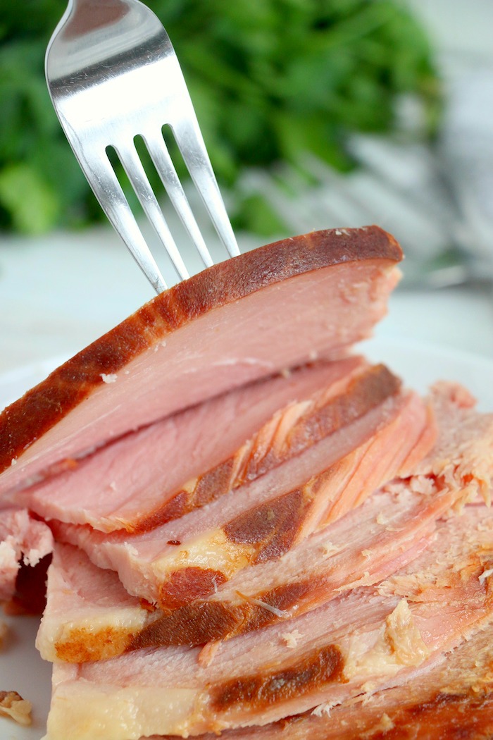 fork picking up a piece of sliced ham