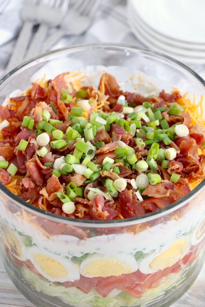 top view of seven layer salad in trifle bowl