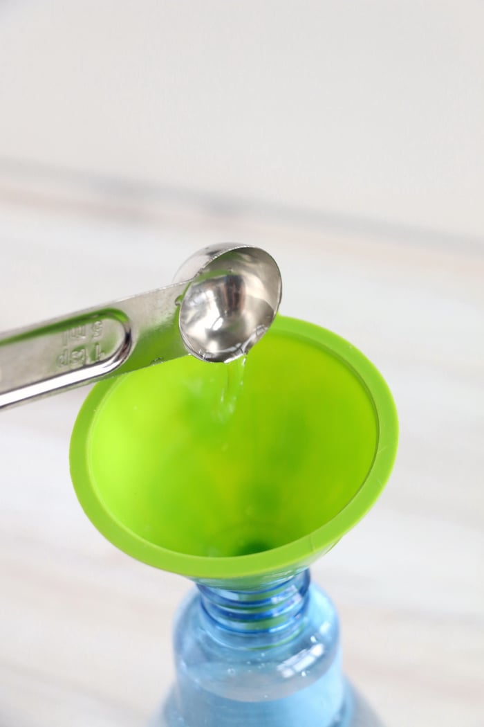 Adding a teaspoon of bleach to a green funnel