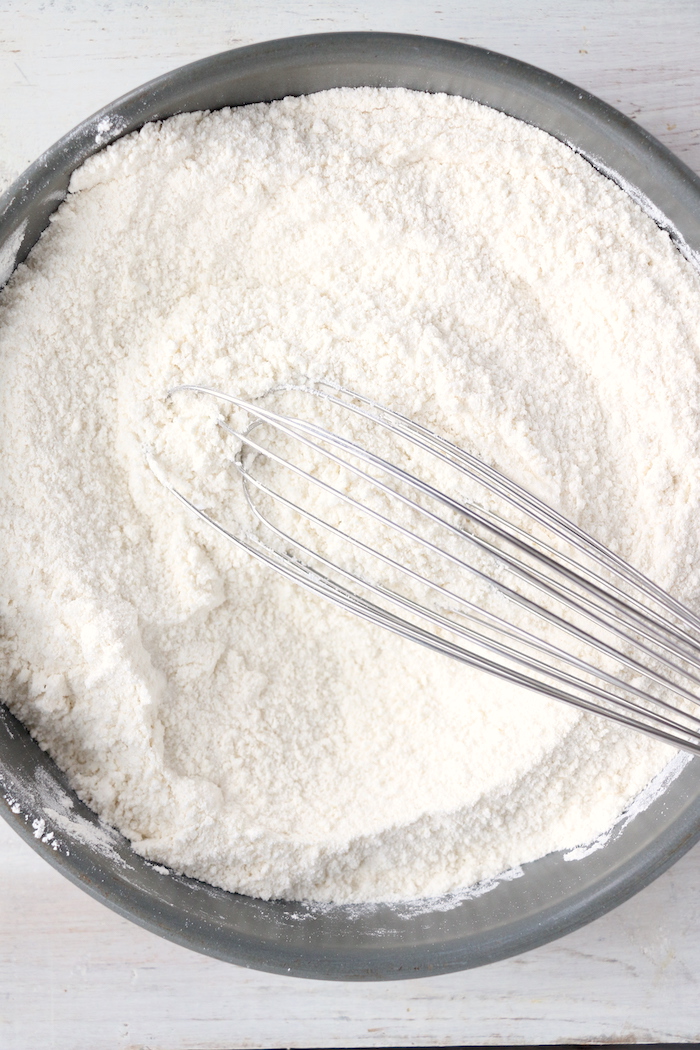 whisking flour in a bowl