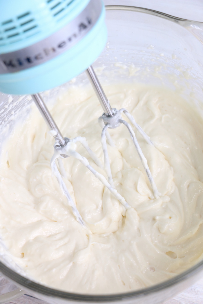 whipping together cream cheese, sugar and evaporated milk