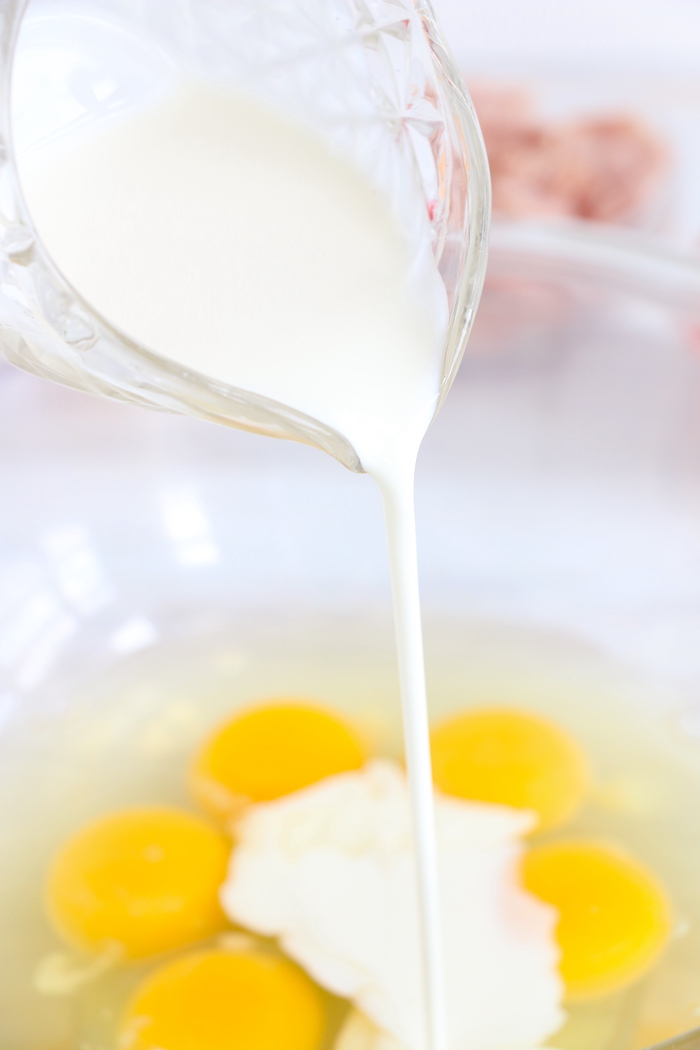 pouring heavy cream into eggs