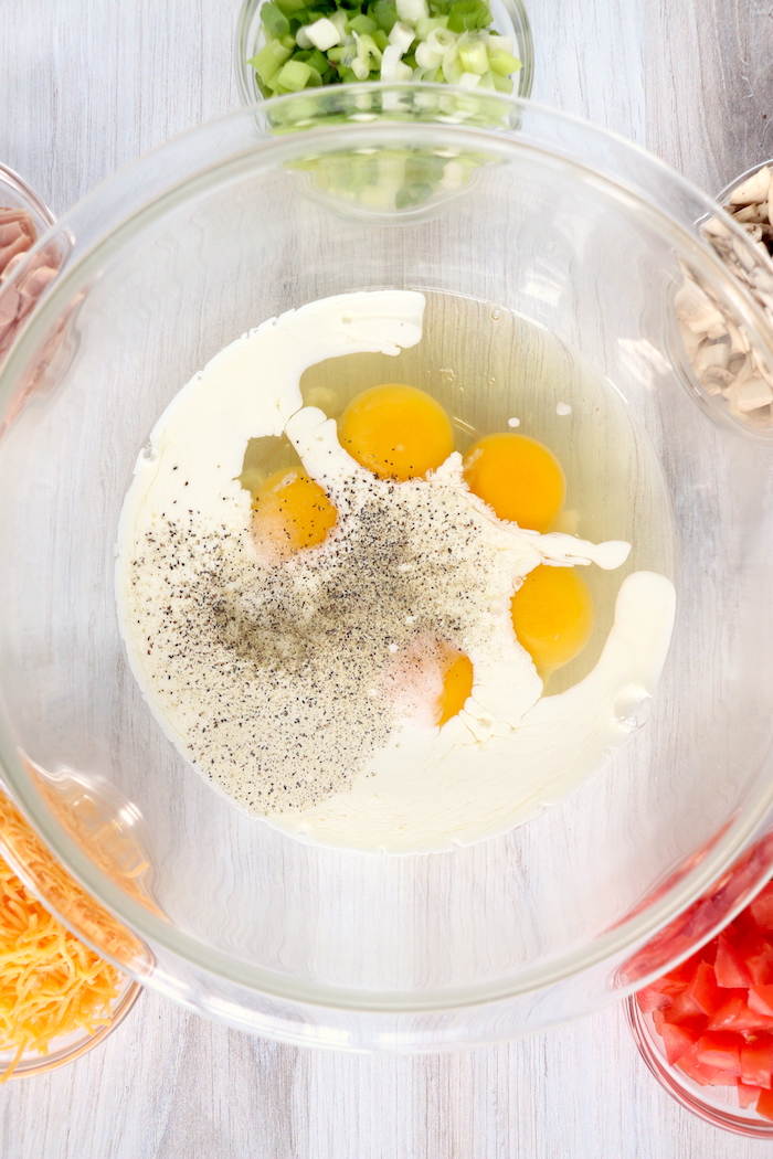 Bowl filled with eggs, heavy cream and salt and pepper