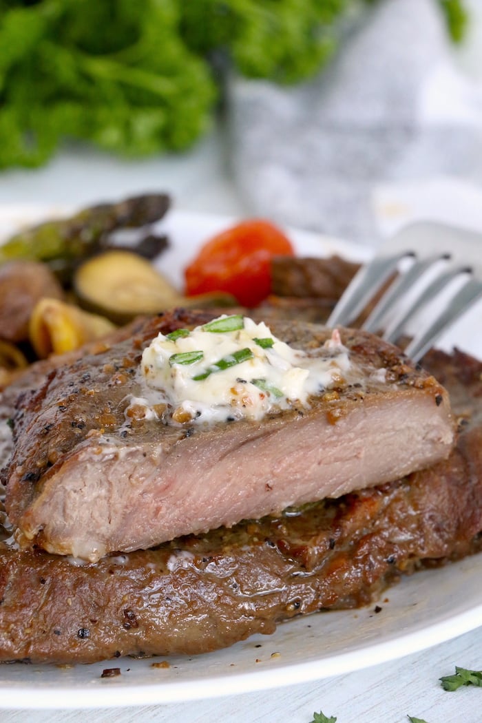 Cut steak done medium with garlic butter topping