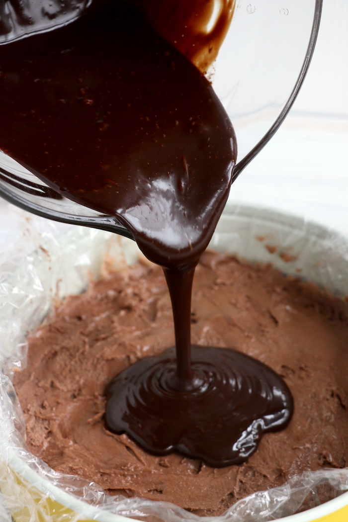 pouring fudge sauce onto chocolate ice cream layer