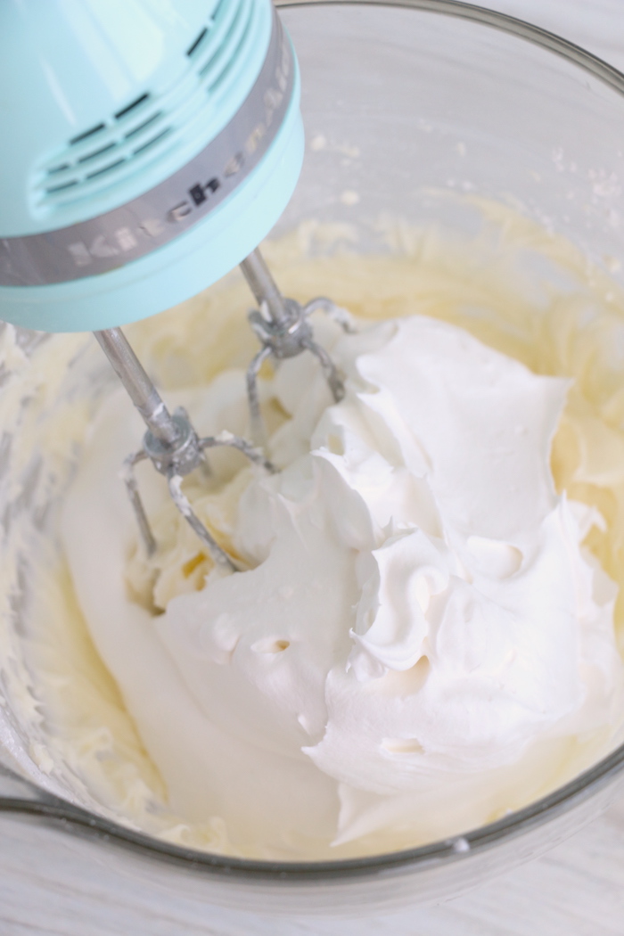 mixing whipped topping in a glass bowl