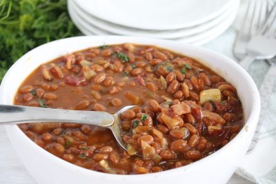 spoon in dish of baked beans