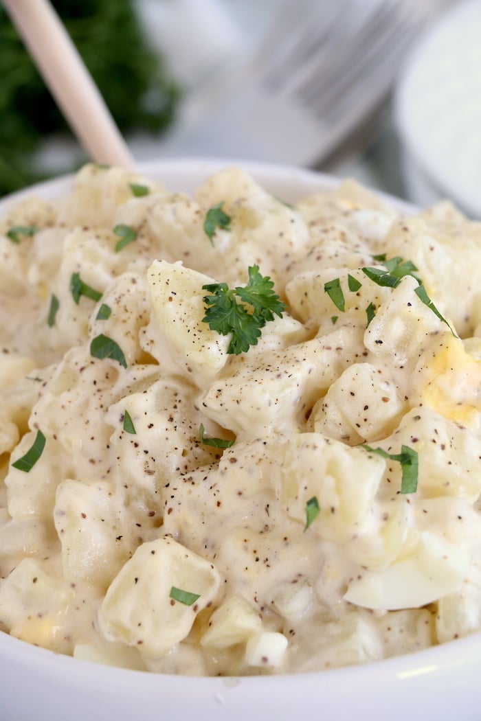 Potato salad with parsley garnish