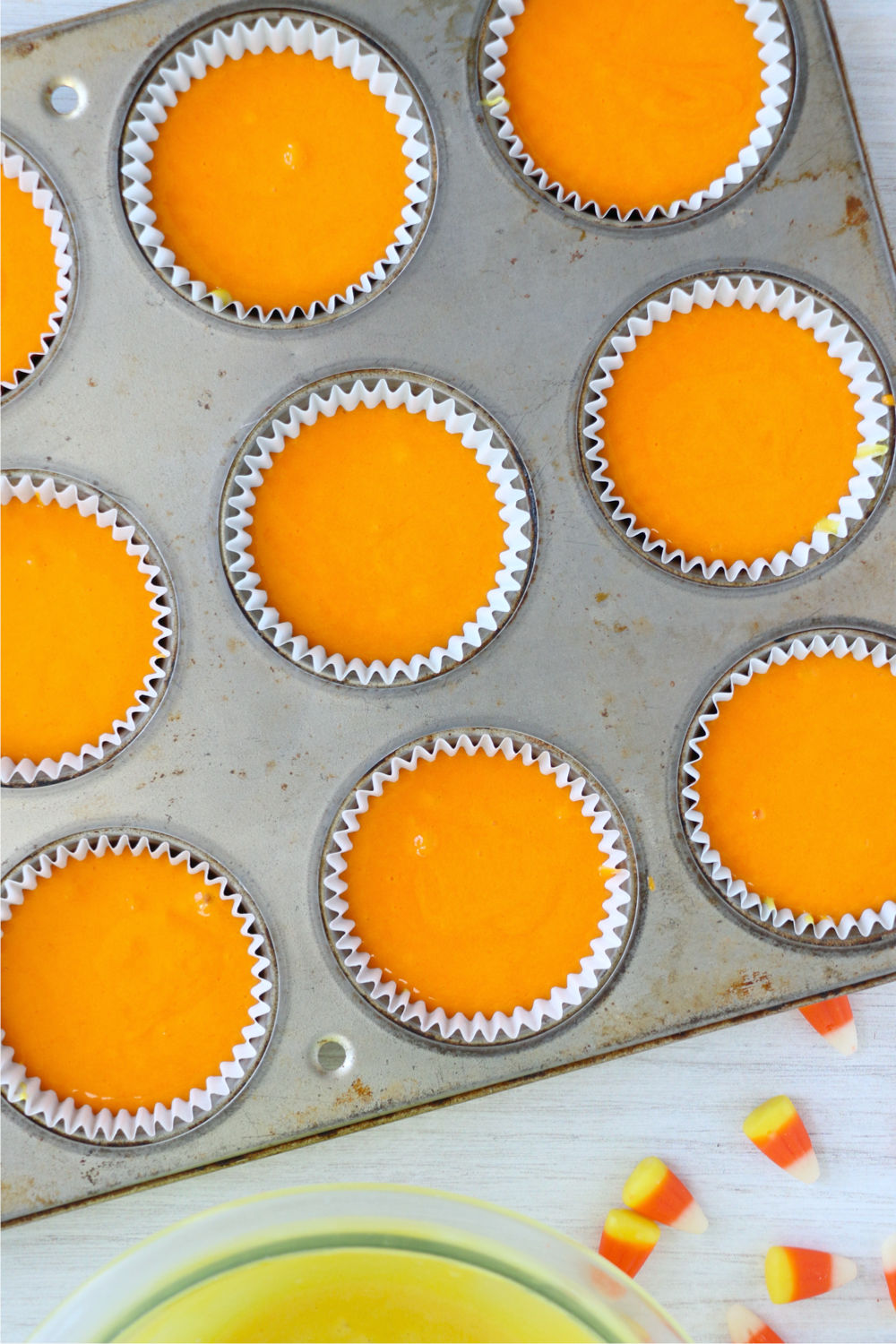 orange batter in cupcake tin
