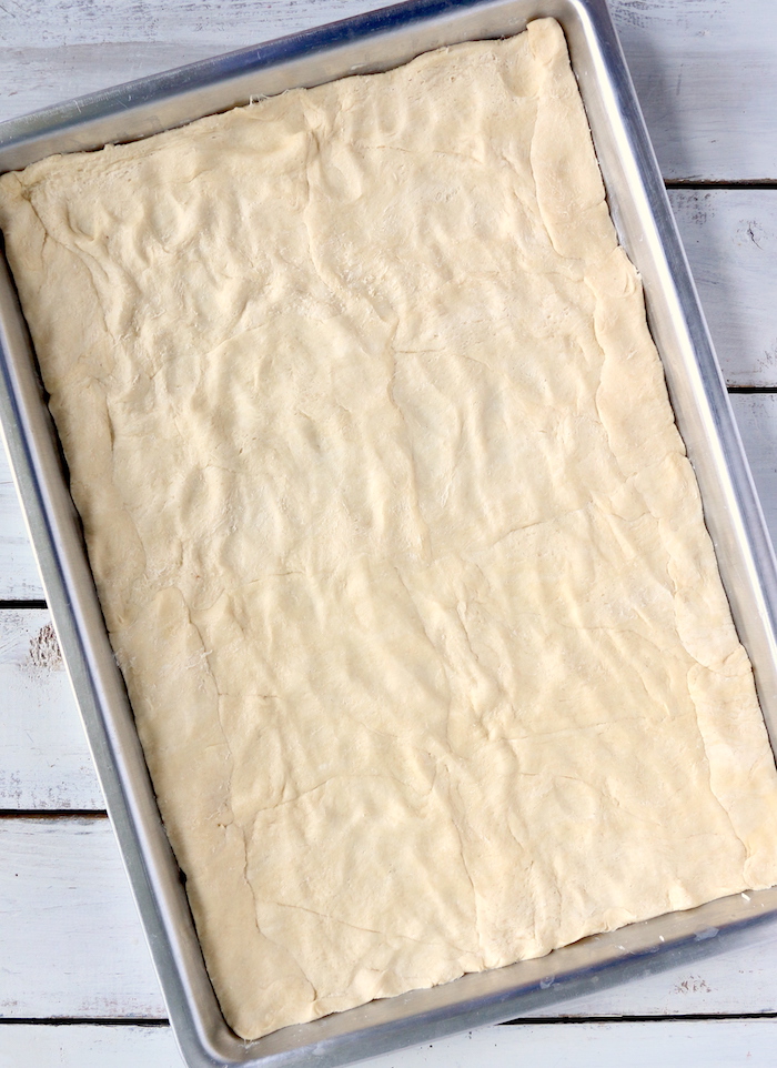 Crescent rolls spread out in baking pan