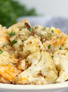 plate of cauliflower topped with cheese and parsley
