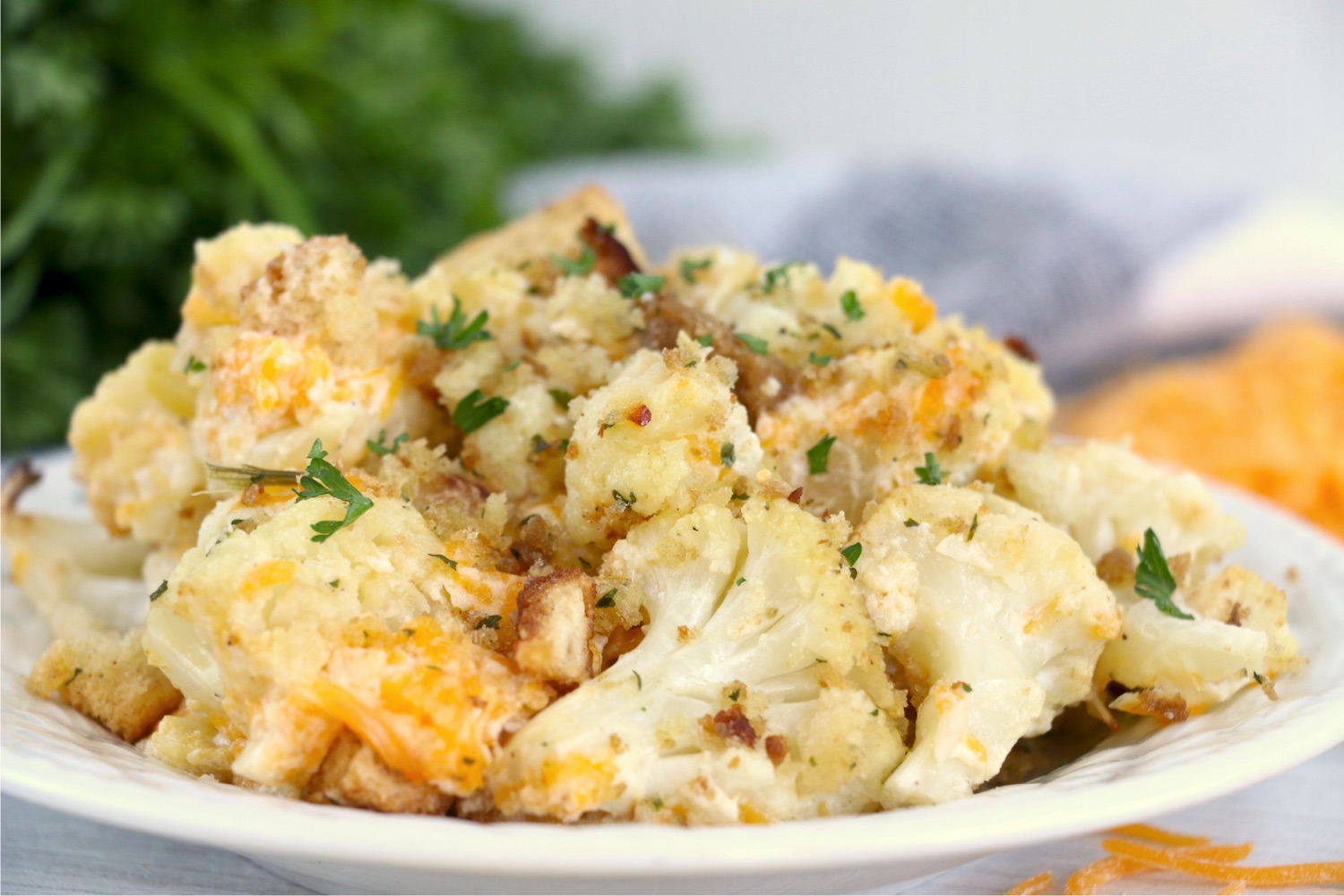 plate of cauliflower topped with cheese and parsley