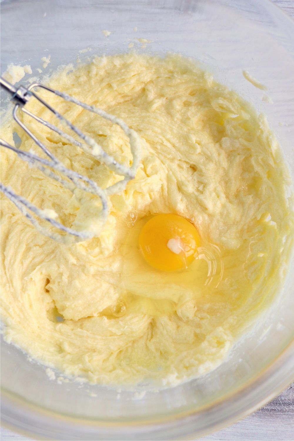 Adding an egg to butter and sugar