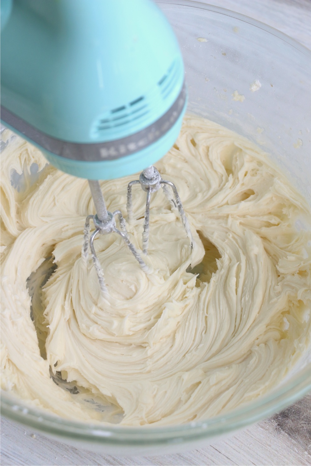 mixing frosting in mixing bowl