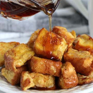 pouring syrup on pieces of french toast